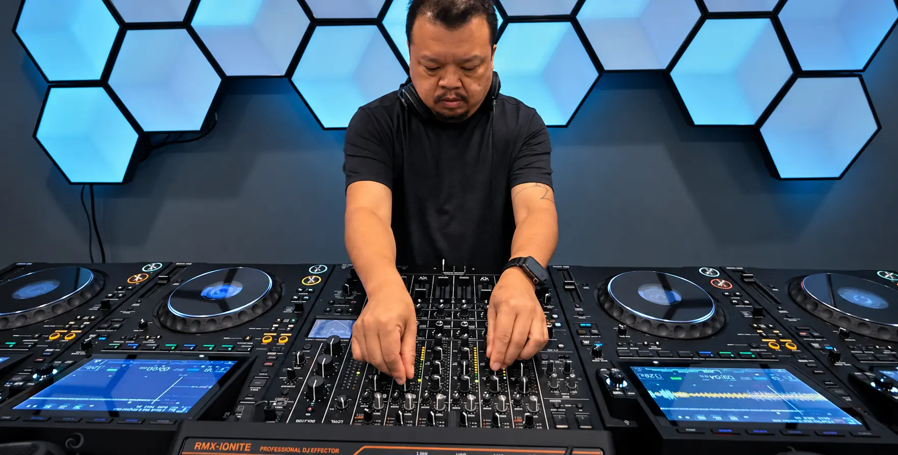 Authentic close-up of hands working the mixer and CDJs